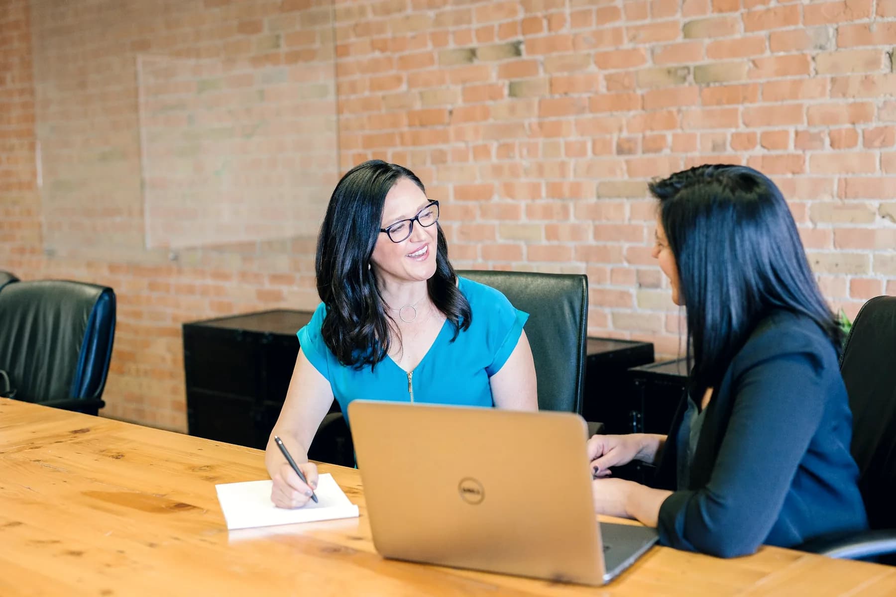Advisor meeting with a client at a desk
