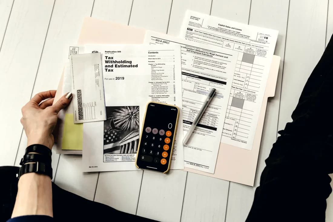 Financial documents and a calculator on a desk
