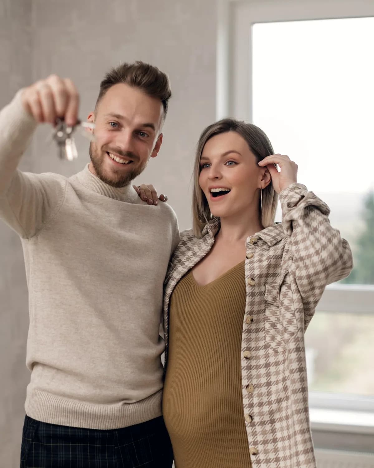 Couple holding up the keys to their new home