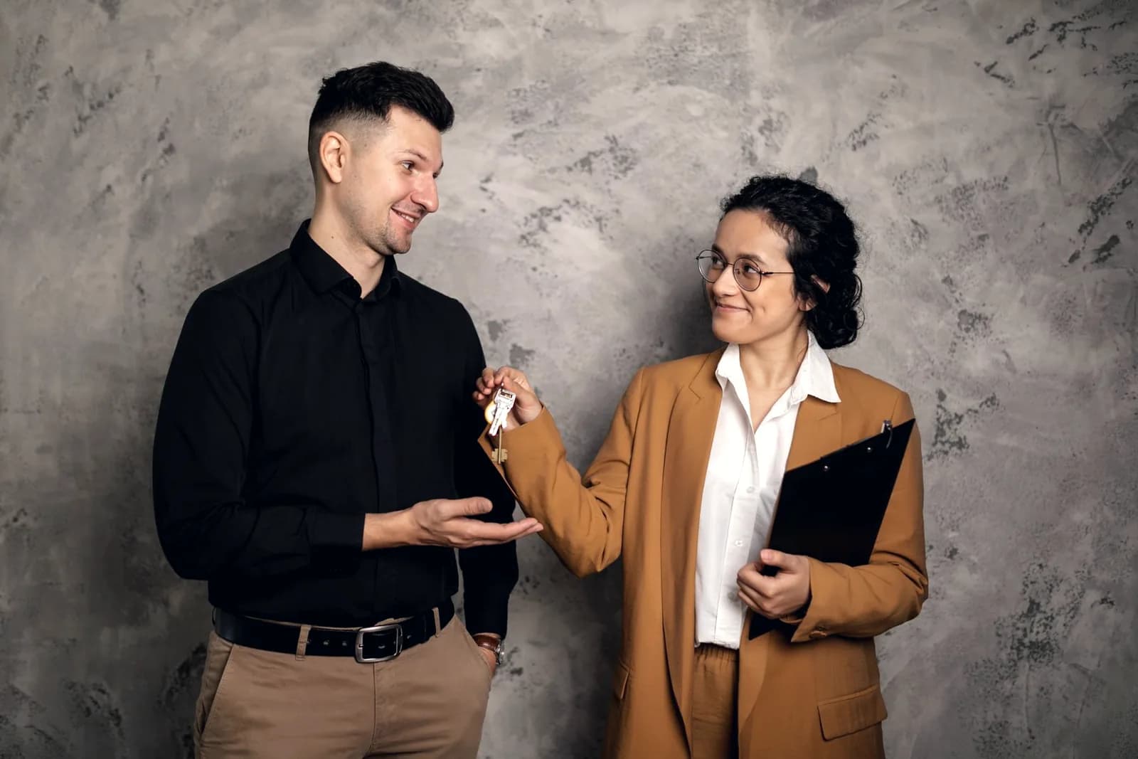 Real estate agent handing house keys to a new homeowner