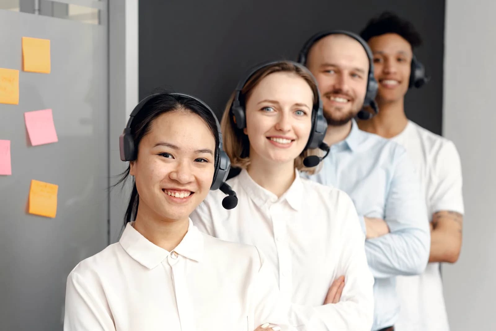 Support specialist wearing a headset, smiling while helping a customer